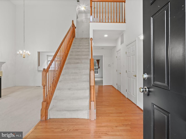 2135 Vittoria Ct Unit 33, Bowie, MD 20721 - foyer featuring stairway, a towering ceiling, a chandelier, and light wood finished floors
