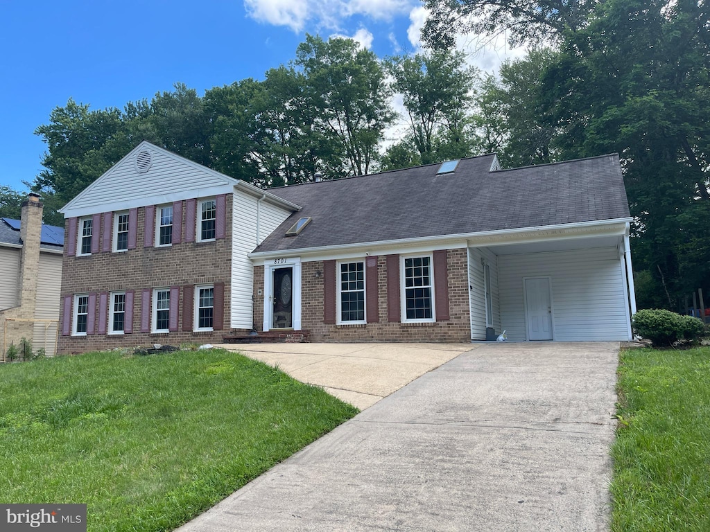8701 Etta Dr, Springfield, VA 22152 - view of front of home featuring concrete driveway, brick siding, a front yard, and an attached carport