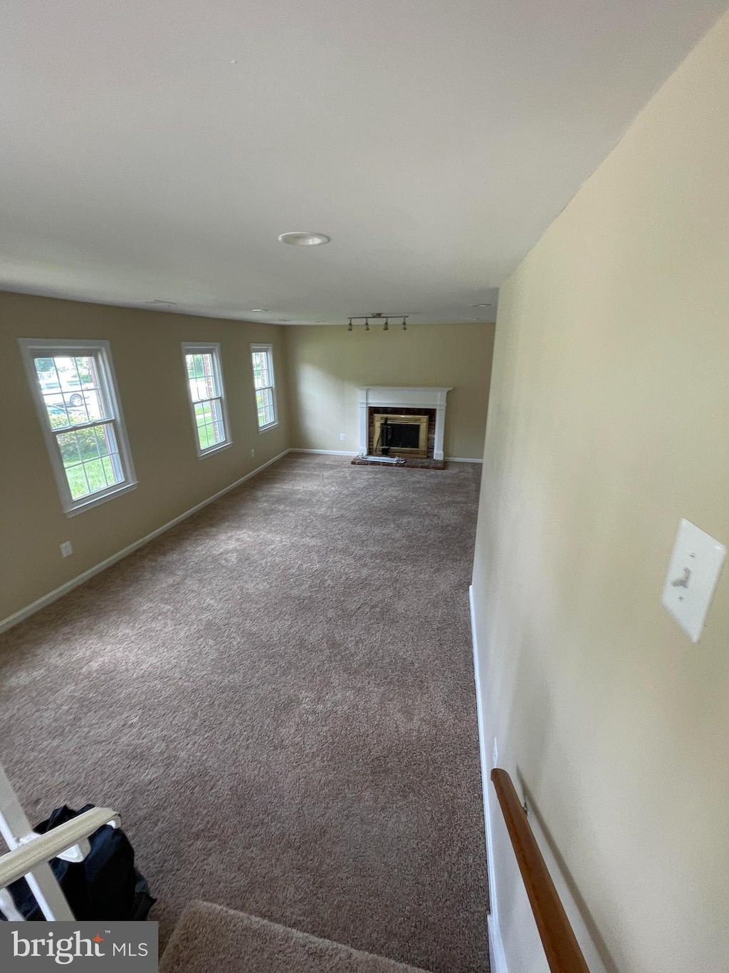 8701 Etta Dr, Springfield, VA 22152 - unfurnished living room featuring carpet and a glass covered fireplace