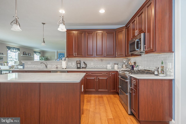 1 Chase Cir, Barto, PA 19504 - kitchen featuring appliances with stainless steel finishes, ornamental molding, backsplash, light wood-type flooring, and decorative light fixtures