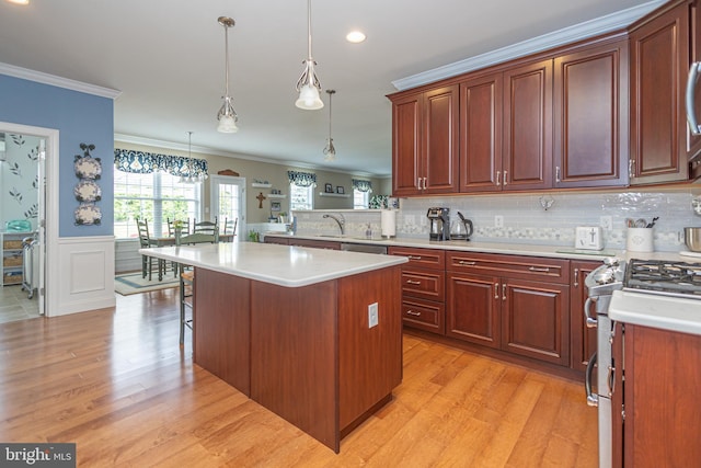 1 Chase Cir, Barto, PA 19504 - kitchen with ornamental molding, stainless steel appliances, light countertops, light wood-style flooring, and a kitchen bar