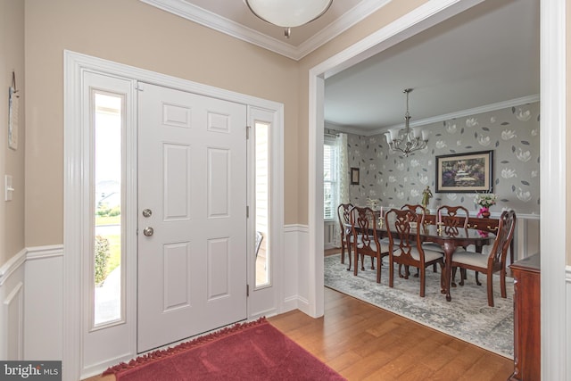 1 Chase Cir, Barto, PA 19504 - entryway featuring wallpapered walls, ornamental molding, a chandelier, wood finished floors, and wainscoting