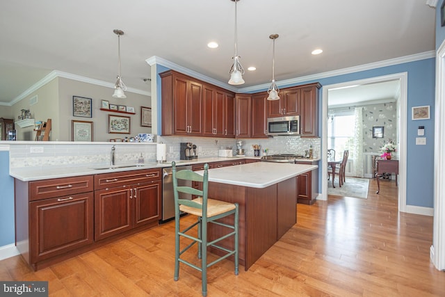 1 Chase Cir, Barto, PA 19504 - kitchen with appliances with stainless steel finishes, light countertops, ornamental molding, light wood-style flooring, and a peninsula