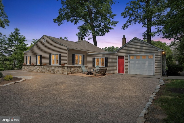 2465 Edgecomb Ave, Glenside, PA 19038 - view of front of house featuring a garage, driveway, a chimney, and stone siding