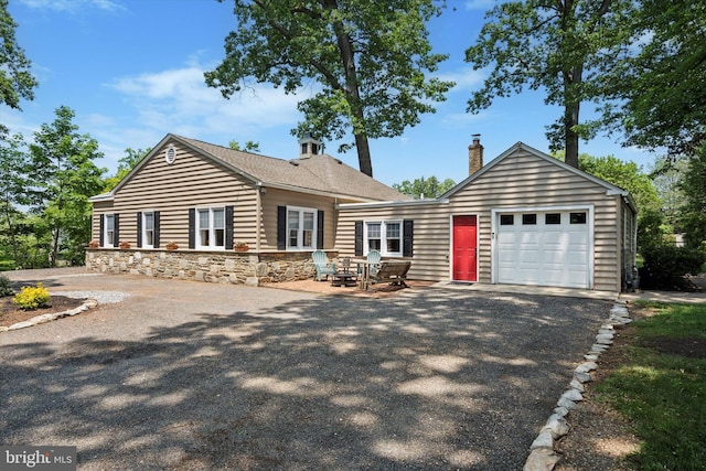 2465 Edgecomb Ave, Glenside, PA 19038 - view of front facade with an attached garage, asphalt driveway, a chimney, and stone siding