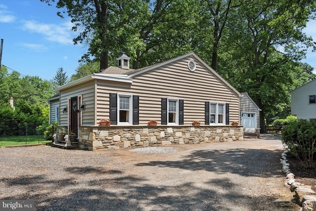 2465 Edgecomb Ave, Glenside, PA 19038 - view of front of house with stone siding, a garage, and driveway