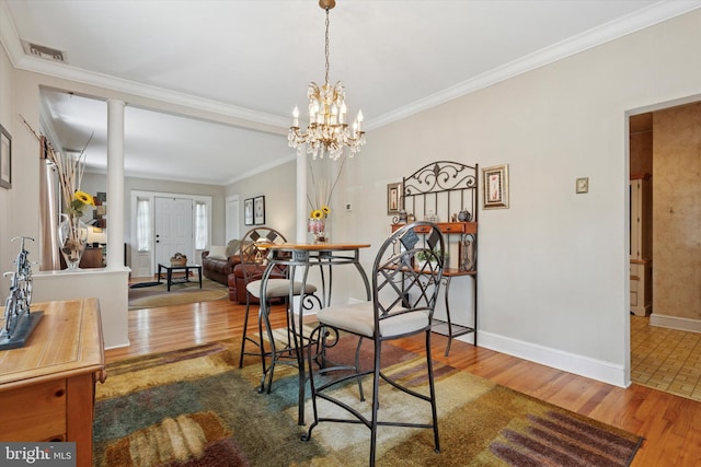 2465 Edgecomb Ave, Glenside, PA 19038 - dining room with wood finished floors, ornamental molding, and a chandelier