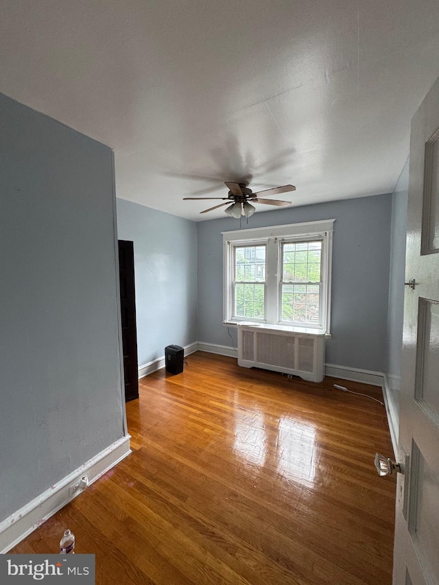 2004 N Jefferson St, Wilmington, DE 19802 - empty room featuring radiator, wood finished floors, and a ceiling fan