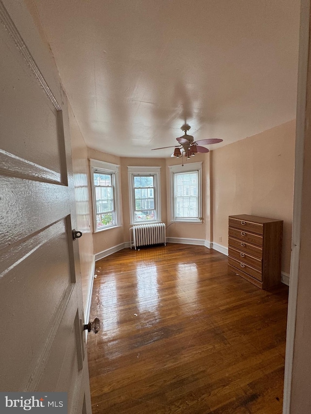 2004 N Jefferson St, Wilmington, DE 19802 - unfurnished living room featuring radiator heating unit, wood finished floors, and ceiling fan