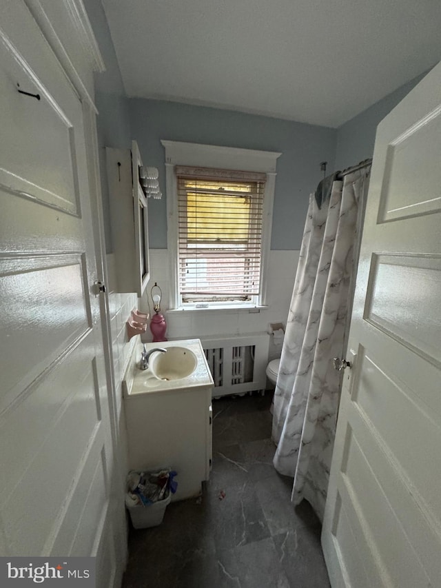 2004 N Jefferson St, Wilmington, DE 19802 - full bathroom featuring vanity, a shower with shower curtain, and a wainscoted wall