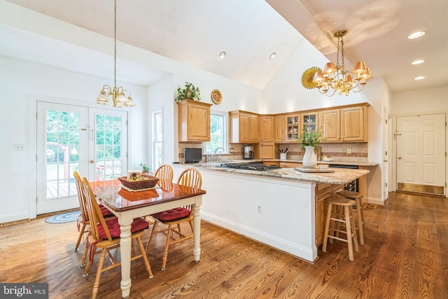 580 Buchanon Rd, Honey Brook, PA 19344 - kitchen with a chandelier, glass insert cabinets, wood finished floors, tasteful backsplash, and recessed lighting