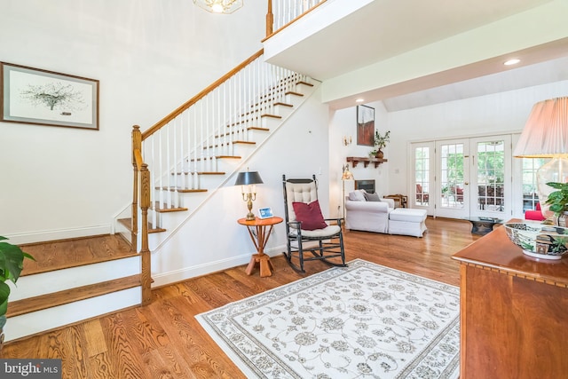580 Buchanon Rd, Honey Brook, PA 19344 - living area with stairs, wood finished floors, french doors, recessed lighting, and a high ceiling