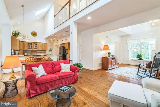 580 Buchanon Rd, Honey Brook, PA 19344 - living room with a chandelier, light wood-style floors, a skylight, high vaulted ceiling, and recessed lighting
