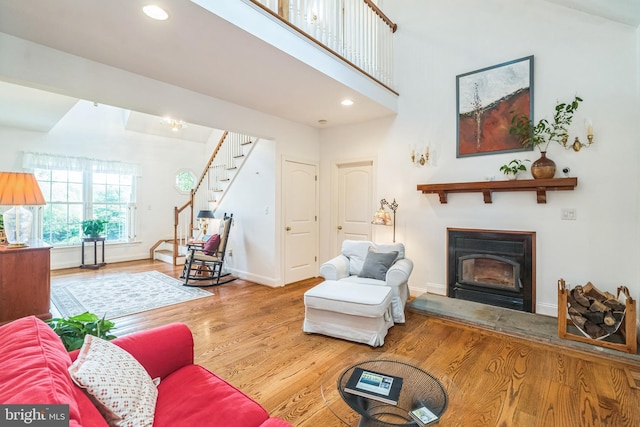 580 Buchanon Rd, Honey Brook, PA 19344 - living area featuring wood finished floors, stairs, a glass covered fireplace, and recessed lighting