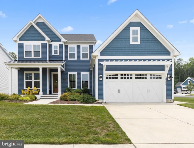 17723 Madaket Way, Lewes, DE 19958 - craftsman house featuring a front yard, covered porch, concrete driveway, and a standing seam roof