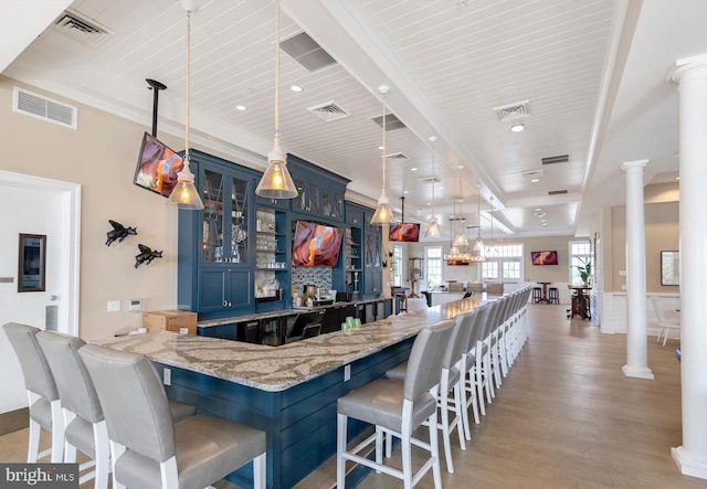 17723 Madaket Way, Lewes, DE 19958 - indoor wet bar with ornate columns, light wood finished floors, decorative light fixtures, and a wood ceiling with exposed beams