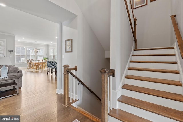 17723 Madaket Way, Lewes, DE 19958 - stairs featuring wood finished floors, crown molding, a chandelier, and recessed lighting