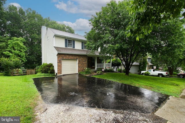 8225 Triple Crown Rd, Bowie, MD 20715 - view of front facade with a chimney, asphalt driveway, brick siding, an attached garage, and covered porch