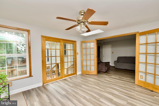 8225 Triple Crown Rd, Bowie, MD 20715 - spare room with ceiling fan, wood finished floors, a skylight, and french doors