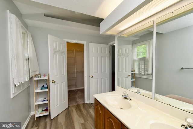 8225 Triple Crown Rd, Bowie, MD 20715 - full bathroom featuring wood finished floors, double vanity, and a walk in closet