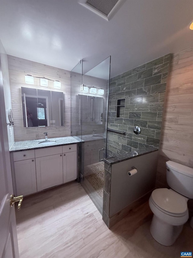1303 Branchlands Dr, Charlottesville, VA 22901 - bathroom featuring vanity, walk in shower, and wood finished floors