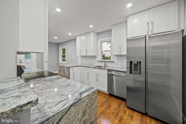 8405 58th Ave, College Park, MD 20740 - kitchen featuring appliances with stainless steel finishes, dark wood finished floors, white cabinetry, decorative backsplash, and recessed lighting