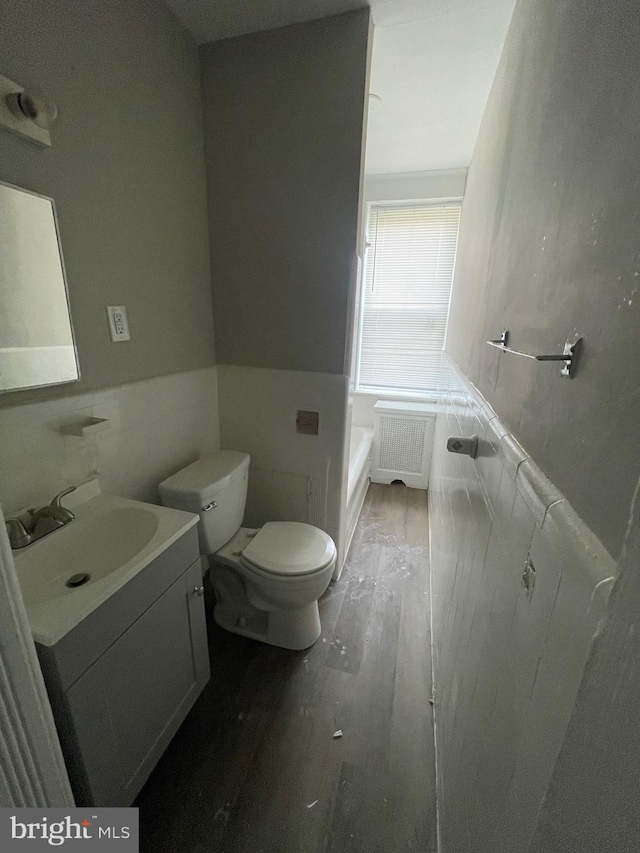 2001 N 52nd St, Philadelphia, PA 19131 - full bathroom with radiator, vanity, wood finished floors, tile walls, and a garden tub