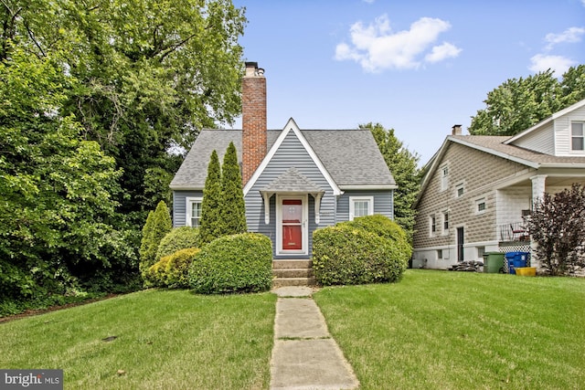 5100 Eugene Ave, Baltimore, MD 21206 - view of front of house featuring a front lawn, roof with shingles, and a chimney