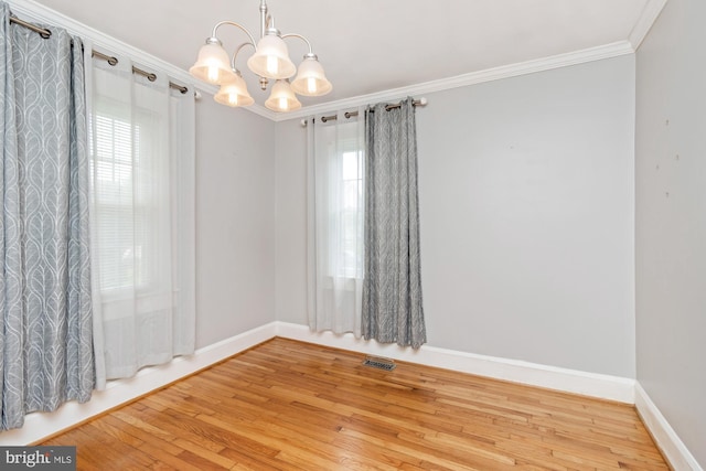 5100 Eugene Ave, Baltimore, MD 21206 - spare room featuring ornamental molding, wood finished floors, and a chandelier
