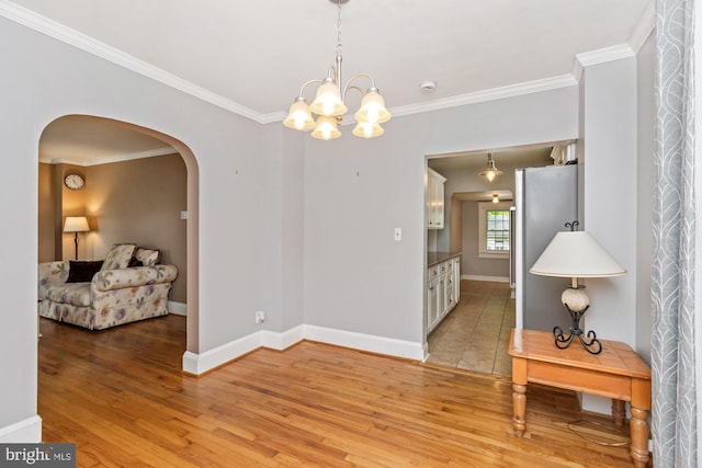 5100 Eugene Ave, Baltimore, MD 21206 - empty room featuring arched walkways, ornamental molding, light wood-style floors, and a chandelier