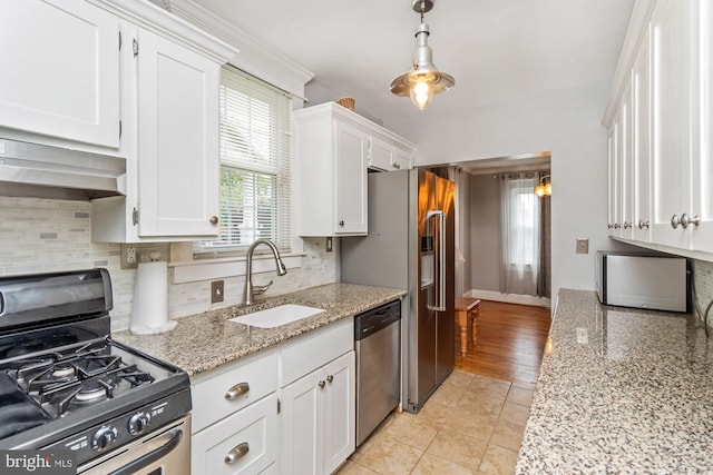 5100 Eugene Ave, Baltimore, MD 21206 - kitchen with appliances with stainless steel finishes, wall chimney range hood, white cabinetry, and decorative backsplash