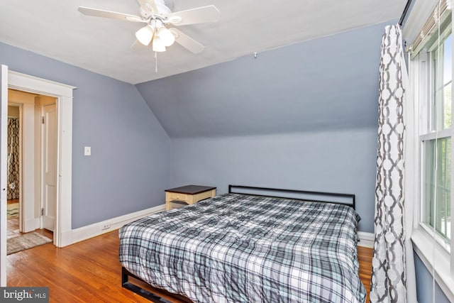 5100 Eugene Ave, Baltimore, MD 21206 - bedroom with wood finished floors, multiple windows, vaulted ceiling, and ceiling fan