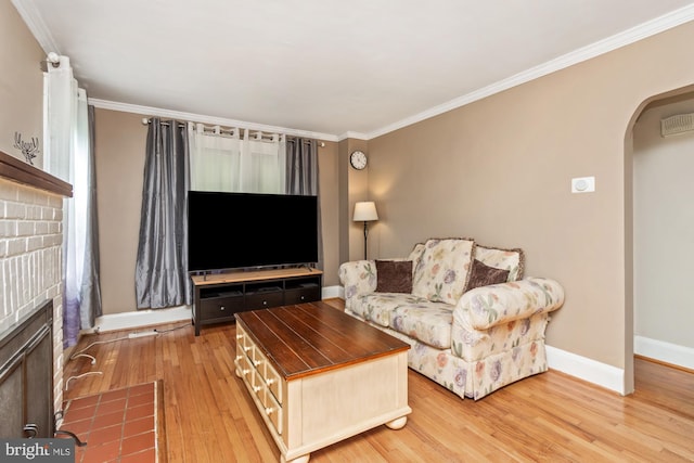 5100 Eugene Ave, Baltimore, MD 21206 - living room with arched walkways, light wood-style floors, ornamental molding, and a brick fireplace