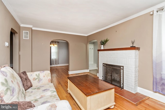 5100 Eugene Ave, Baltimore, MD 21206 - living room featuring arched walkways, light wood finished floors, ornamental molding, and a fireplace