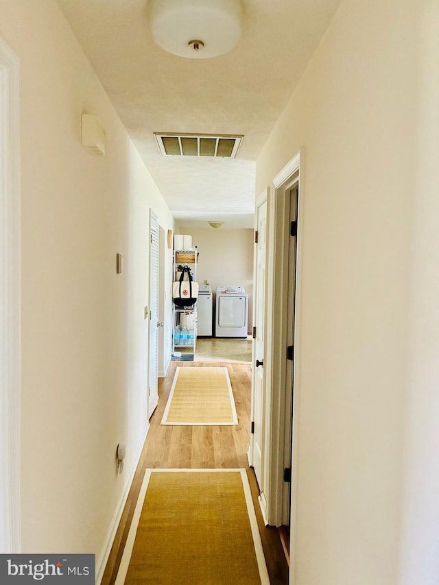 817 Maple Ave, Waynesboro, VA 22980 - corridor featuring independent washer and dryer and wood finished floors