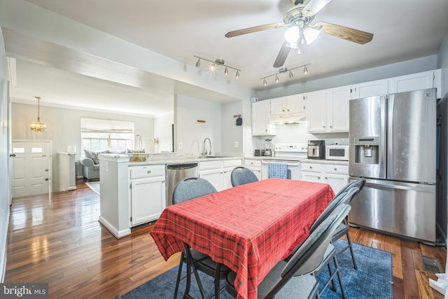 15198 Wentwood Ln, Woodbridge, VA 22191 - dining space featuring dark wood-type flooring, a ceiling fan, a chandelier, and rail lighting
