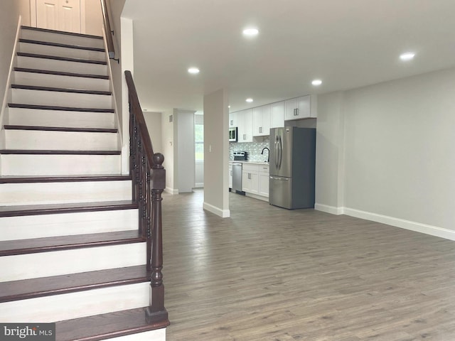 1319 Rainer Rd, Brookhaven, PA 19015 - staircase featuring wood finished floors and recessed lighting