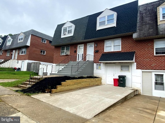 1319 Rainer Rd, Brookhaven, PA 19015 - view of front facade featuring roof with shingles and brick siding