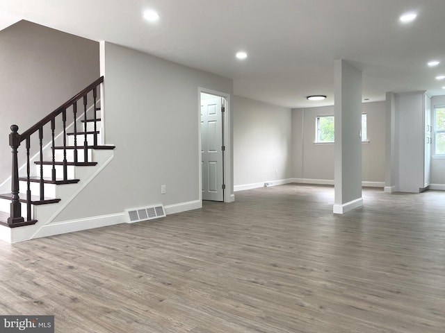 1319 Rainer Rd, Brookhaven, PA 19015 - unfurnished living room with wood finished floors, recessed lighting, plenty of natural light, and stairway