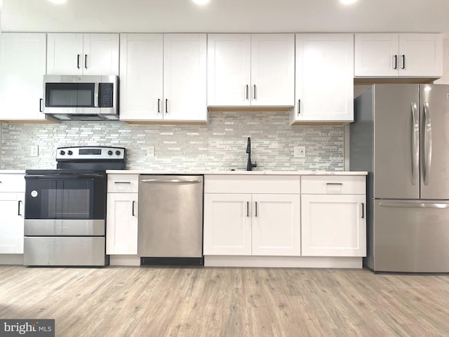 1319 Rainer Rd, Brookhaven, PA 19015 - kitchen featuring appliances with stainless steel finishes, white cabinets, and light countertops