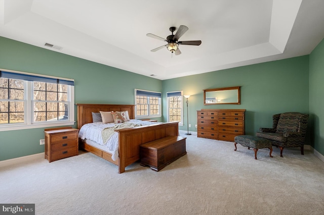 12773 Beebe Ct, Lovettsville, VA 20180 - carpeted bedroom featuring a raised ceiling, multiple windows, and a ceiling fan