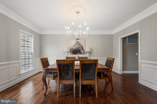 12773 Beebe Ct, Lovettsville, VA 20180 - dining space featuring a chandelier, dark wood-style flooring, ornamental molding, wainscoting, and a decorative wall