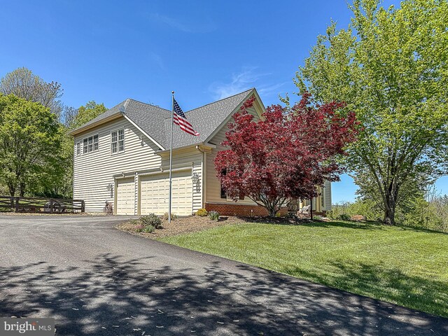 12773 Beebe Ct, Lovettsville, VA 20180 - view of side of home featuring an attached garage, asphalt driveway, a yard, and roof with shingles