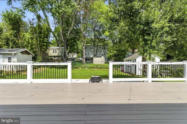 13727 Mahoney Dr, Woodbridge, VA 22193 - wooden terrace with an outdoor fire pit, a yard, and a residential view