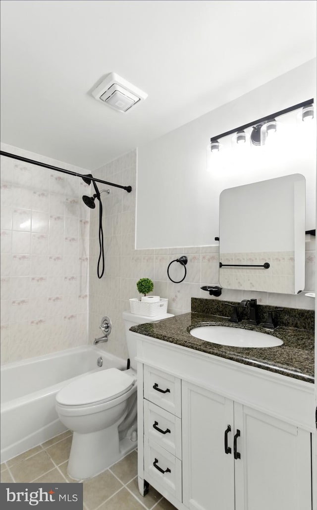 13727 Mahoney Dr, Woodbridge, VA 22193 - bathroom with vanity, shower / washtub combination, tile patterned floors, and tile walls
