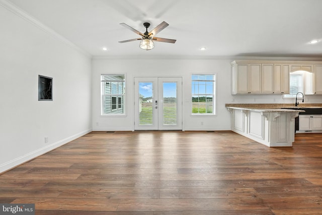 9936 Bell Wood Farm Ln, Nokesville, VA 20181 - kitchen featuring ornamental molding, ceiling fan, a breakfast bar area, open floor plan, and dark wood-style flooring