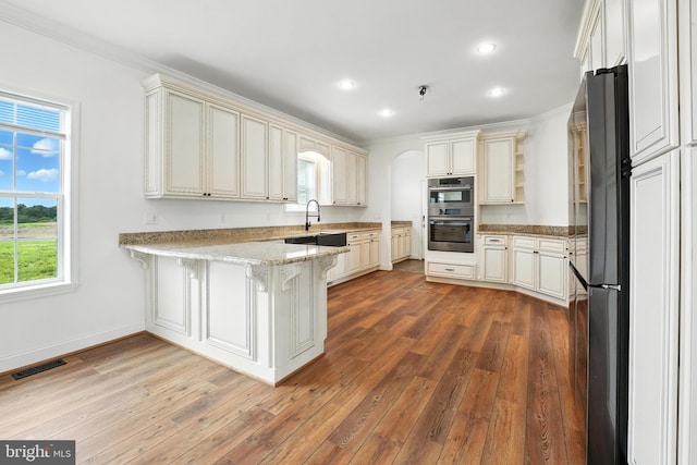 9936 Bell Wood Farm Ln, Nokesville, VA 20181 - kitchen featuring double oven, open shelves, a peninsula, freestanding refrigerator, and ornamental molding