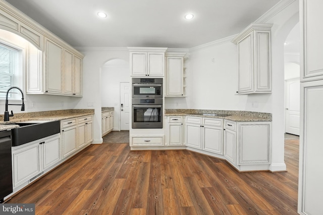 9936 Bell Wood Farm Ln, Nokesville, VA 20181 - kitchen with arched walkways, double oven, dark wood-style flooring, recessed lighting, and light stone counters