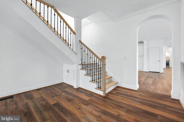 9936 Bell Wood Farm Ln, Nokesville, VA 20181 - stairs featuring arched walkways, hardwood / wood-style floors, and ornamental molding
