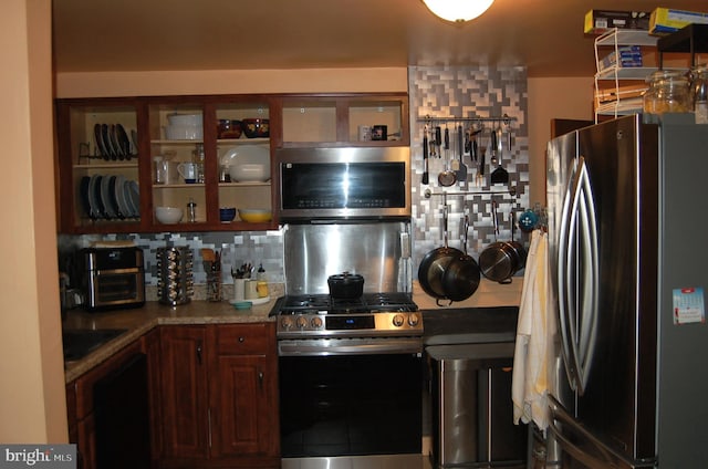 1400 Windsor Ave, Wilmington, DE 19804 - kitchen with stainless steel appliances, decorative backsplash, and glass insert cabinets